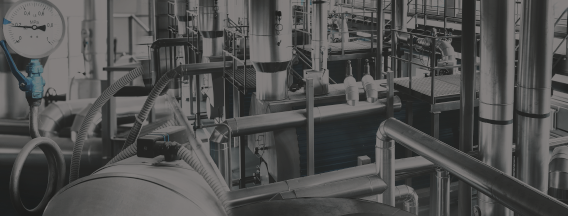 Industrial processing system with various pipes, valves, and gauges.